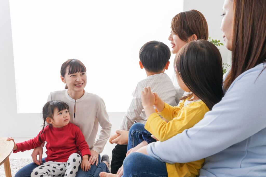 Moms with kids playing